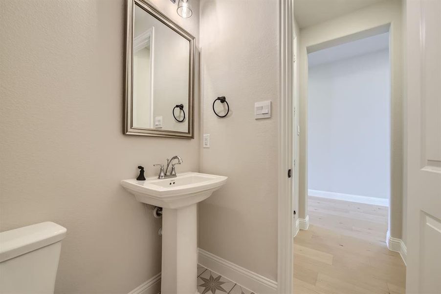 Bathroom with sink, wood-type flooring, and toilet