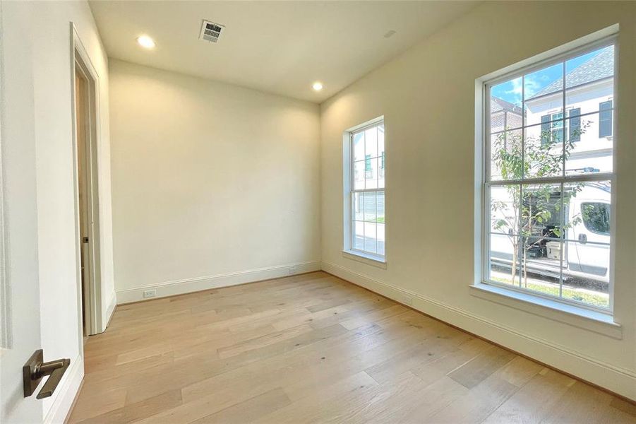 Two secondary bedrooms located on the first floor with a shared bath. Photo of actual home under construction.