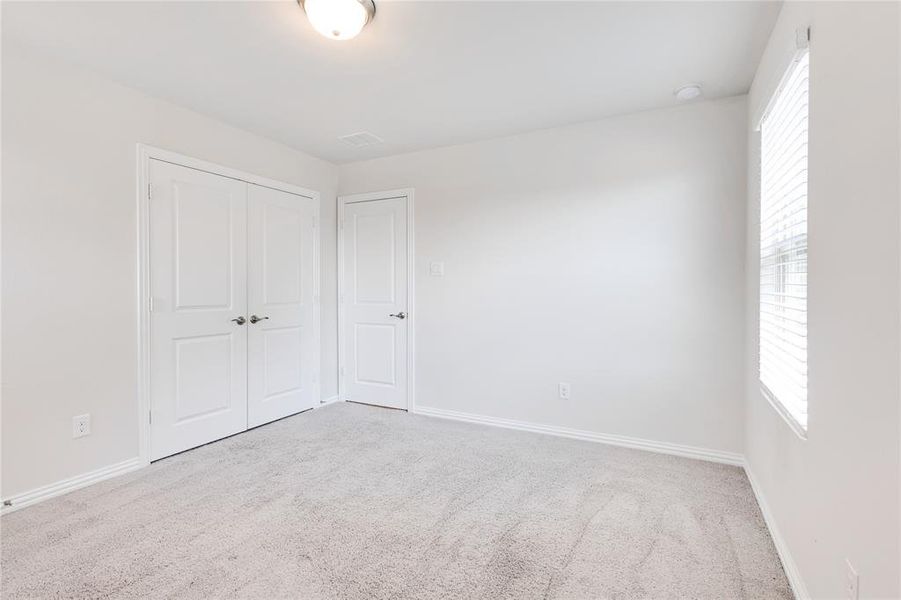 Unfurnished bedroom with carpet floors and a closet