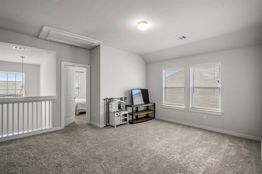 Another spacious secondary bedroom featuring bright natural light, LED lighting, plush carpet, and large closet. *This photo has been virtually staged