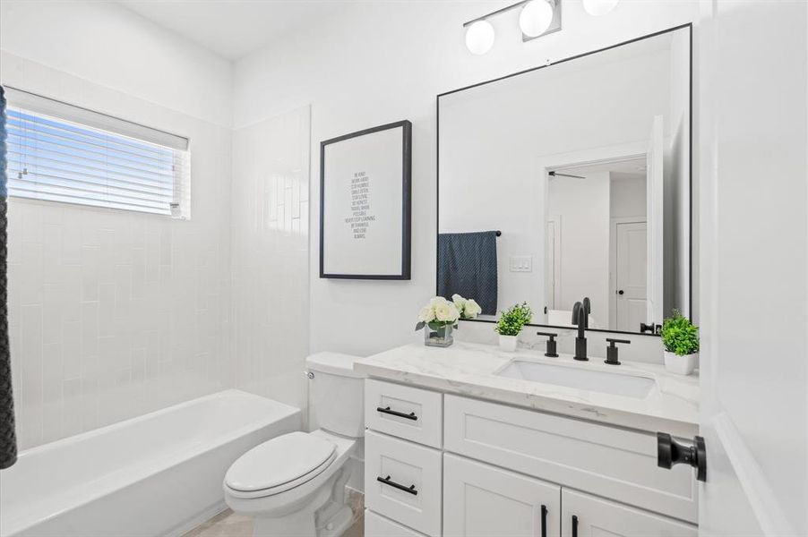 Quartz countertops, oversized mirrors, and an abundance of natural light are only a few of the features you can expect to enjoy in all three bathrooms of this home! *All interior photos are from the model home: 5216 Pine Tree*