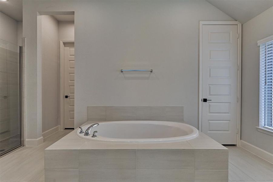 Attractive soaking tub in the centerpiece of this spa-like retreat! Don't miss the dual closets as well!