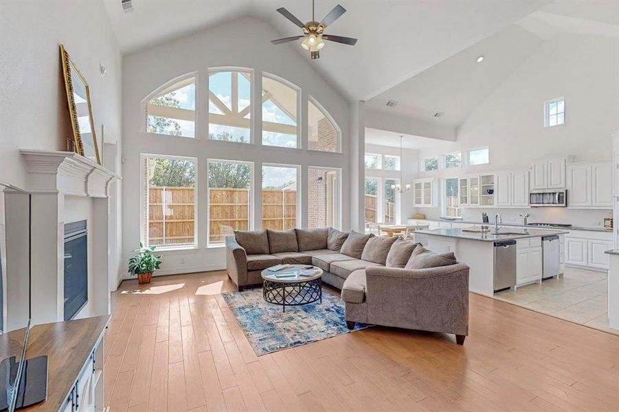 Large Living Room with Open Floor Plan with high vaulted ceiling and oversized windows which provide tons of natural light and an even more spacious feel.