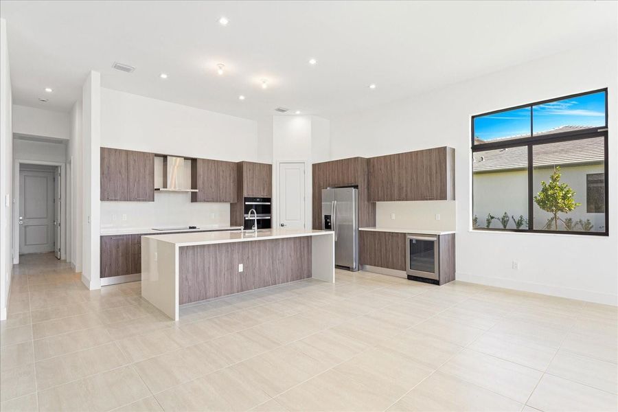 Very large custom island with waterfall in the kitchen