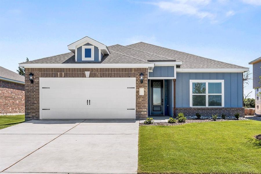 View of front of property with a 2 car garage and a front yard