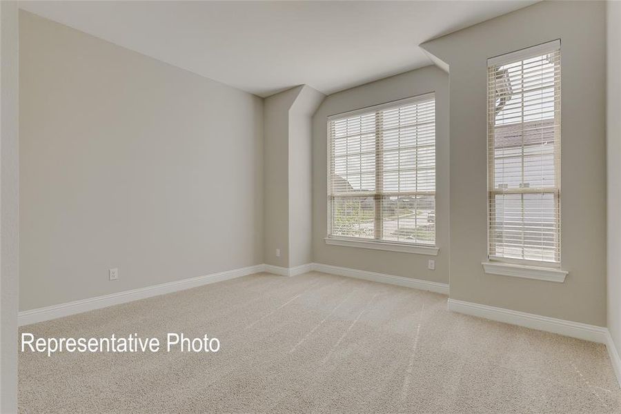 Empty room featuring light carpet