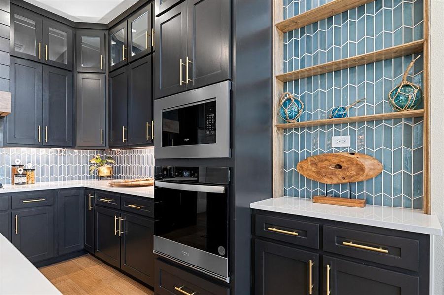 Kitchen with tasteful backsplash and stainless steel appliances