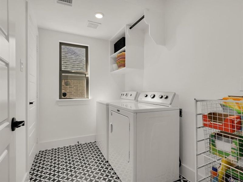 Spacious downstairs laundry room with additional storage.