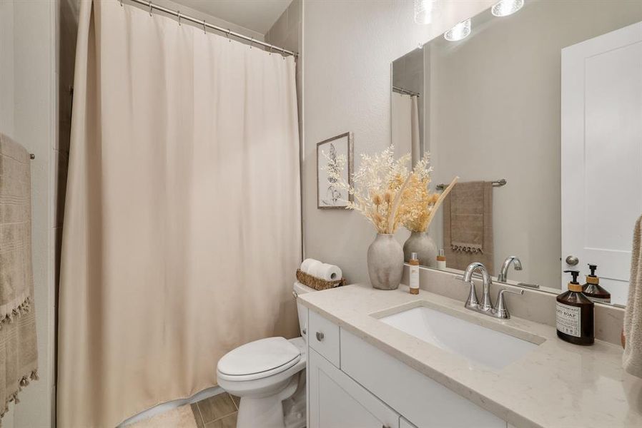 Full bath with floor to ceiling tile in shower/bath.