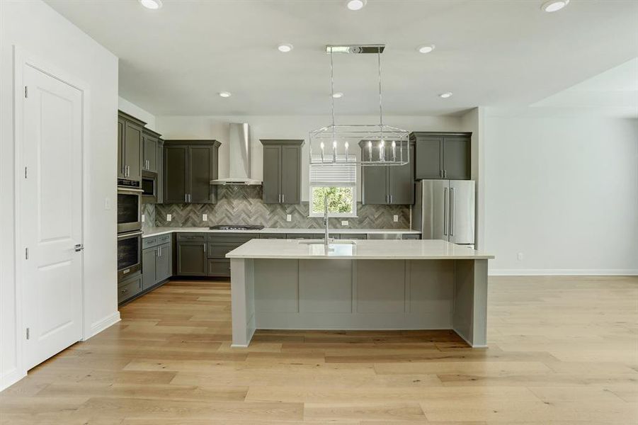 The kitchen overlooks the dining room and the family room in this marvelous plan.