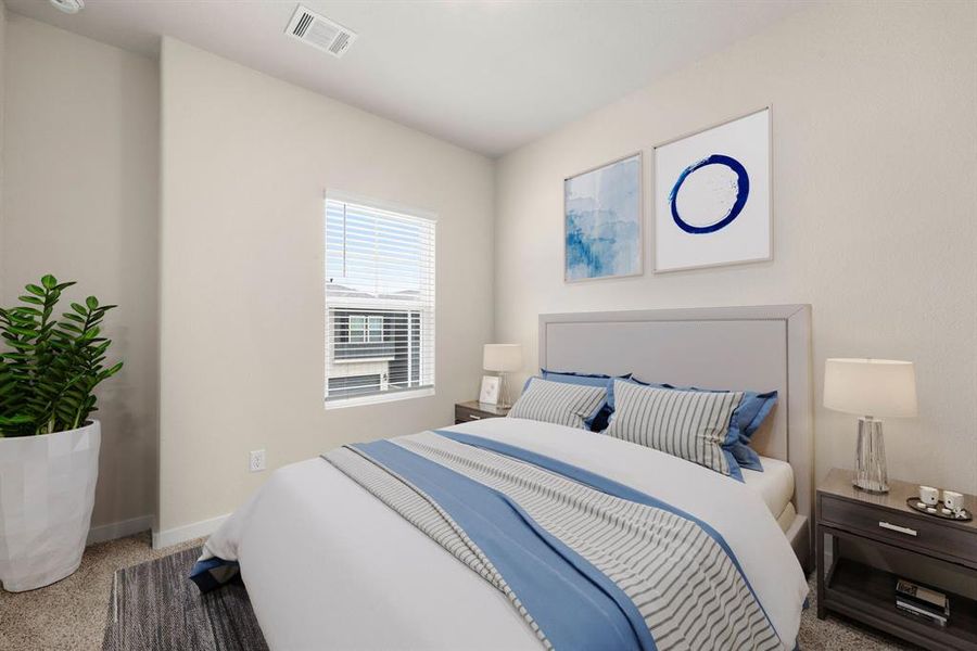 Secondary bedroom features plush carpet, neutral paint, large window and ample closet space.