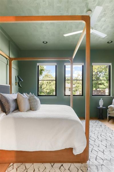 Bedroom with multiple windows and ceiling fan