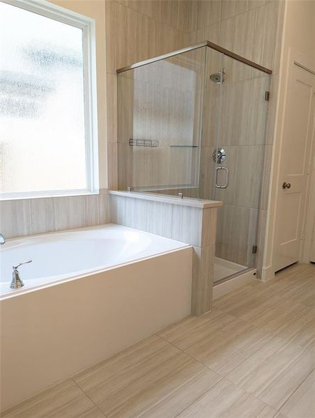 Primary Bath has a stand up shower and separate soaking tub
