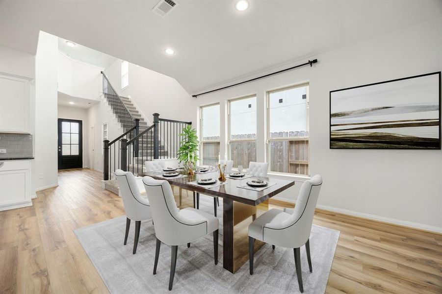 Make memories gathered around the table with your family and friends! This dining room features high ceilings, recessed lighting, large windows, and rich wood floors.