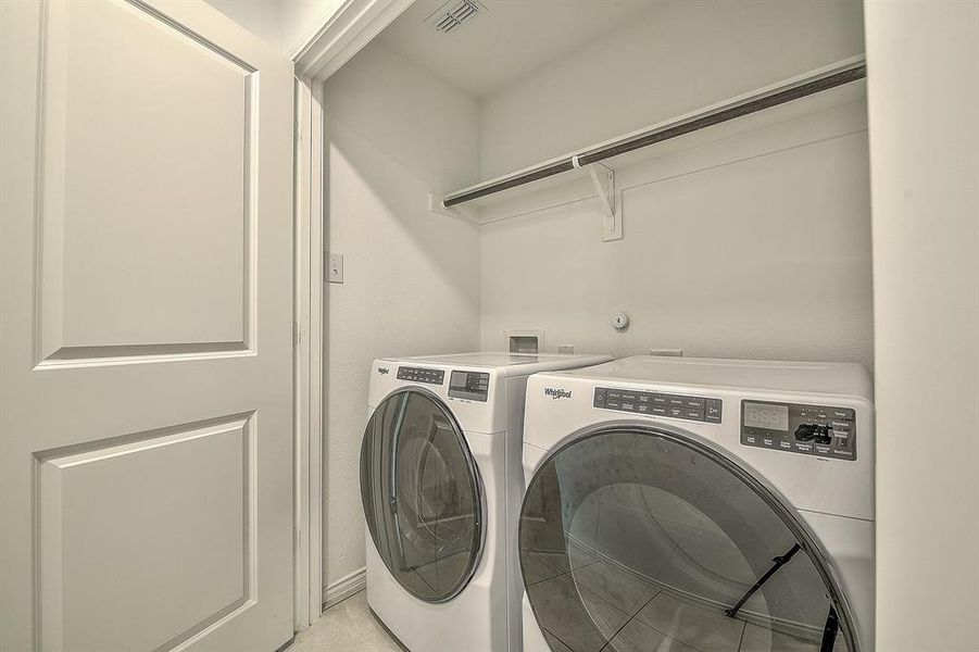 Washroom featuring independent washer and dryer