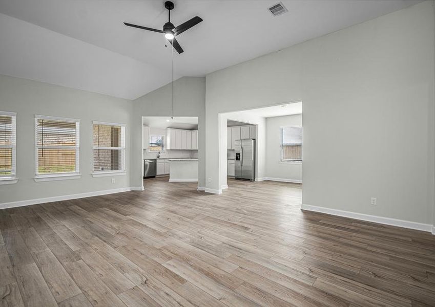 Spacious family room with plank flooring and a ceiling fan