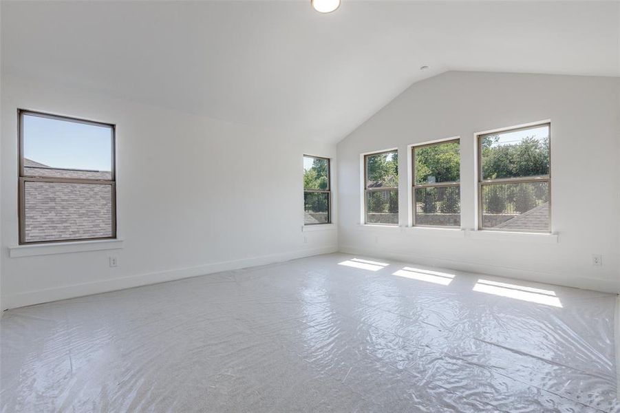 Empty room with lofted ceiling