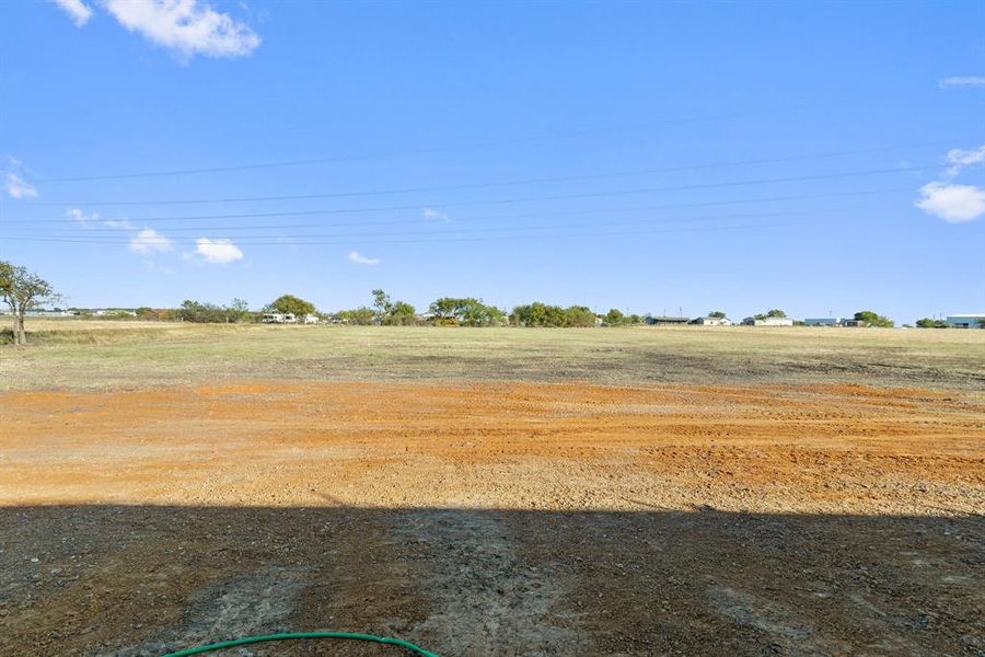 View of yard with a rural view