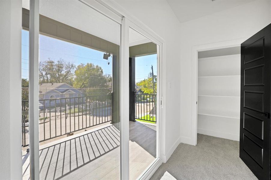 Doorway to outside featuring light carpet