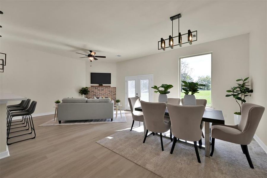 Dining area and more living space with a cozy corner fireplace.