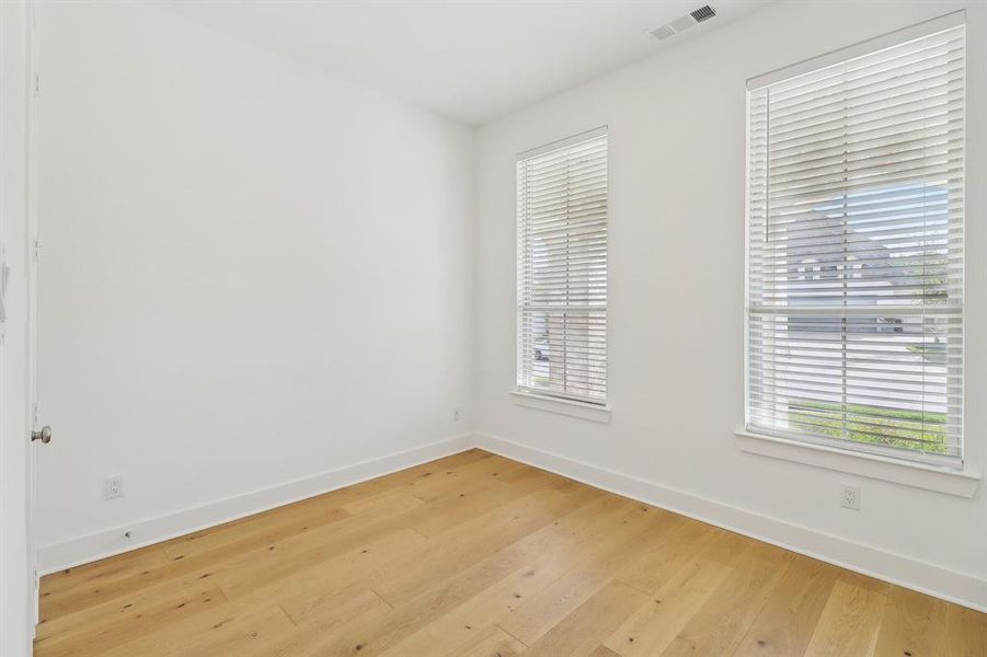 Unfurnished room with light hardwood / wood-style flooring