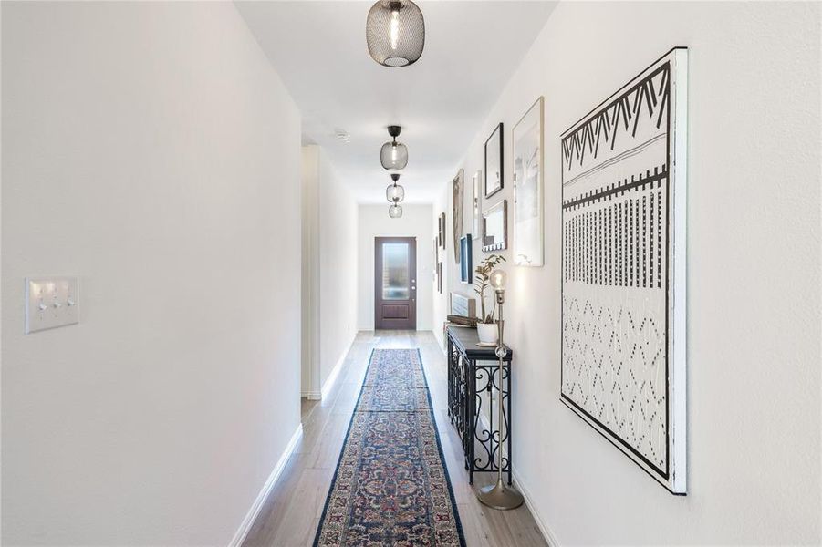 Hall with light hardwood / wood-style flooring