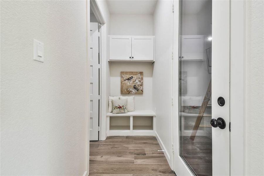 Mud room conveniently located near Garage.  Notice the glass & steel door leading to the garage