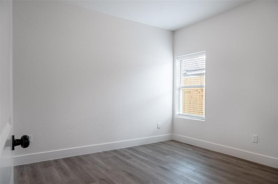 Unfurnished room with dark hardwood / wood-style floors