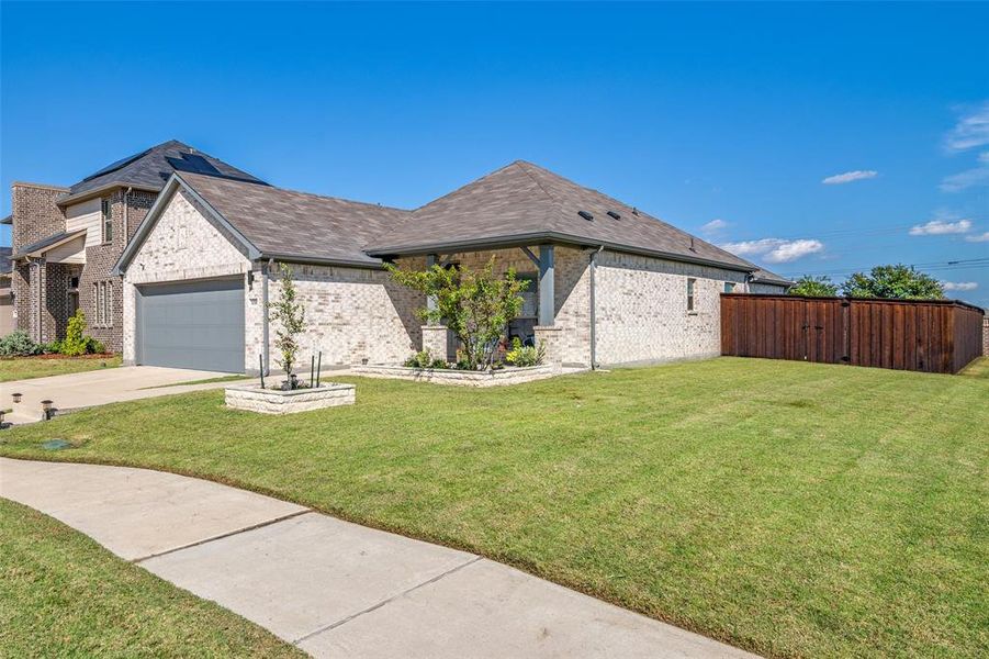 View of front of house featuring a front yard and a garage