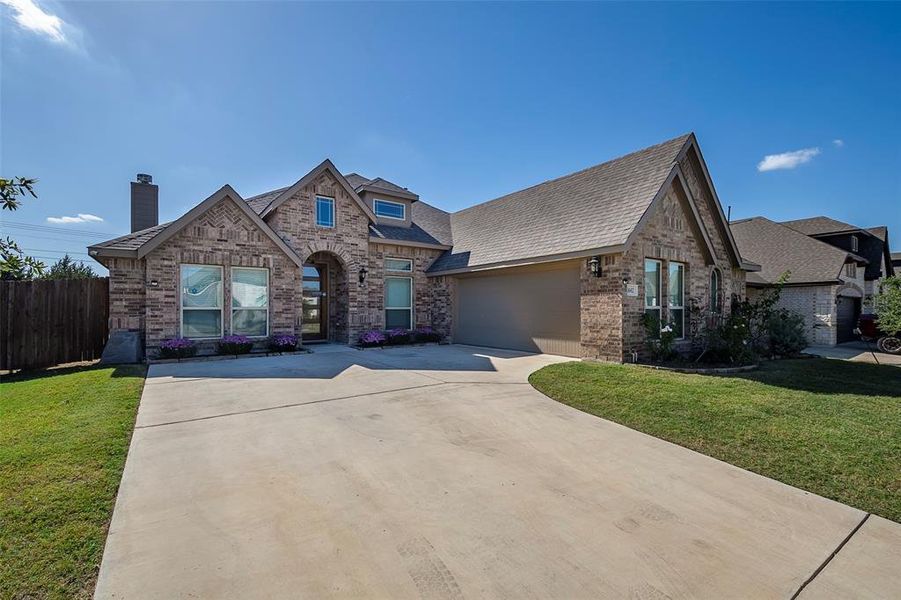 View of front of house with a front yard and a garage