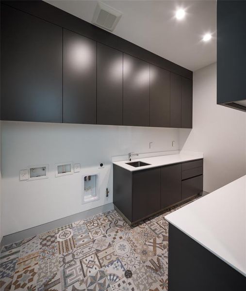 Second floor laundry room with built-ins, sink and tile floors with elegant design