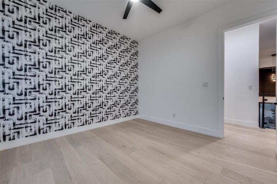 Empty room featuring light hardwood / wood-style flooring and ceiling fan