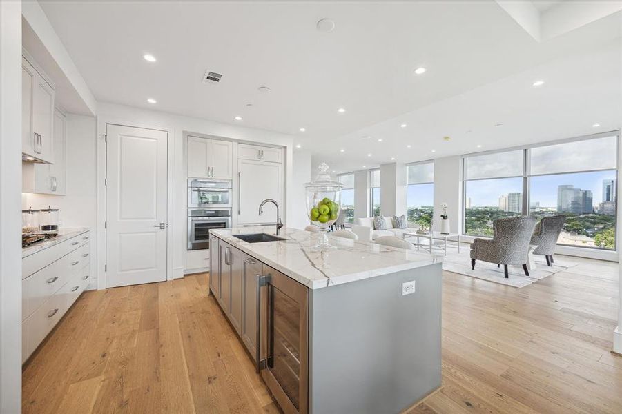 From this angle you can see the wine fridge conveniently tucked away into the island and enjoy the view with the full wall of windows.