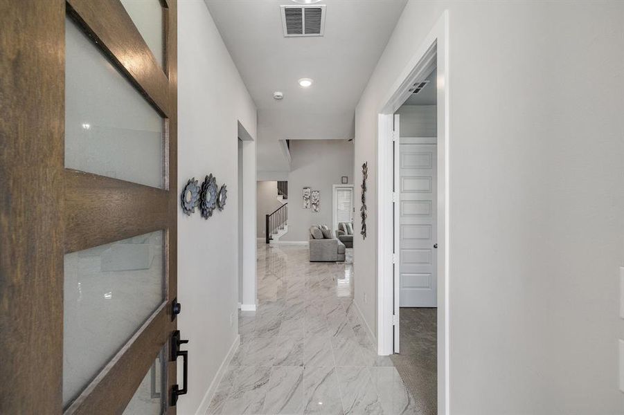 Hall with light tile patterned floors