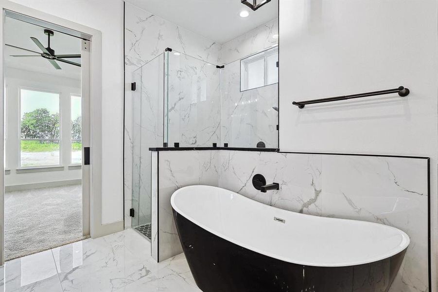 Bathroom featuring tile walls, separate shower and tub, and ceiling fan