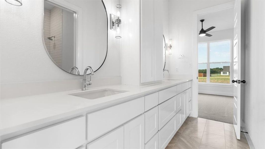 Bathroom featuring ceiling fan and vanity