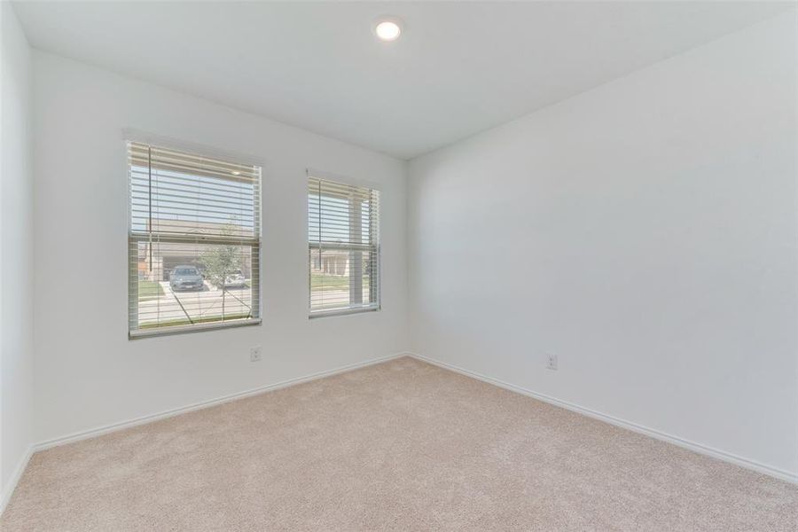 Empty room with light colored carpet