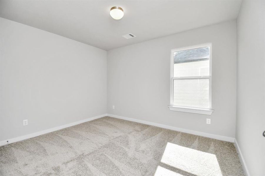 Another perspective of the secondary bedroom with plenty of natural light.