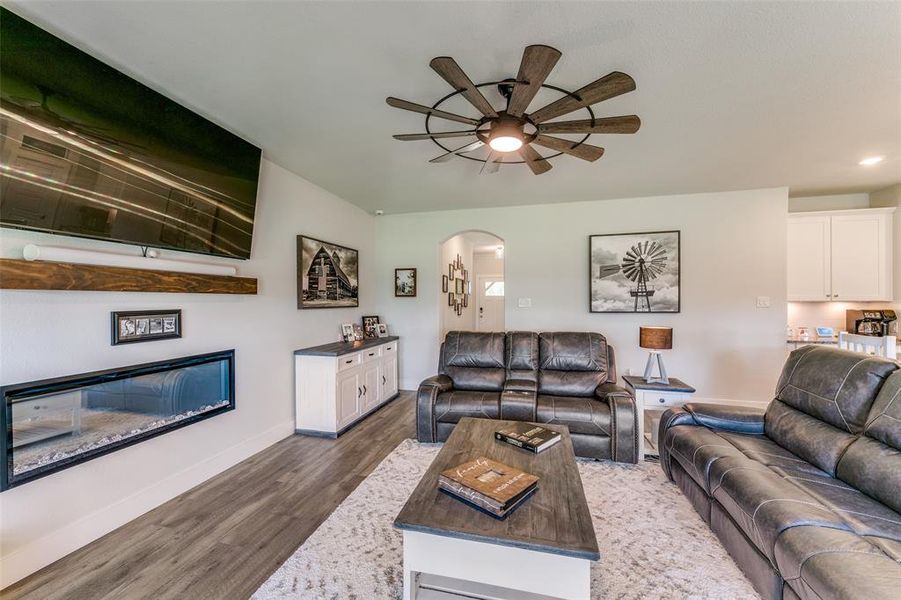 Living room featuring ceiling fan and dark hardwood / wood-style floors