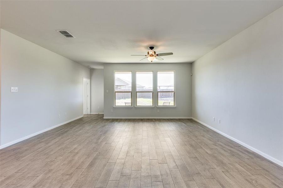 Empty room featuring light hardwood / wood-style flooring and ceiling fan