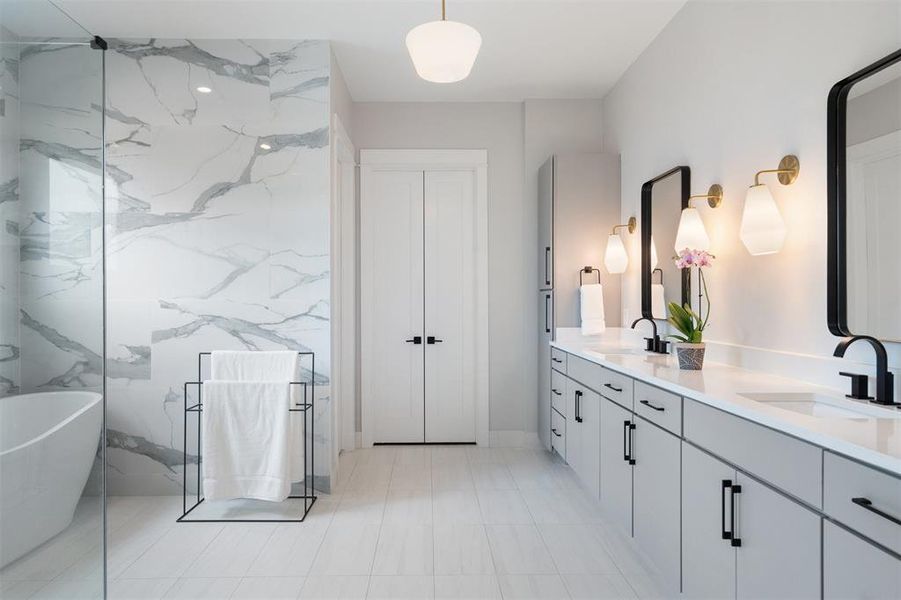 In the spa-like ensuite bath, a dual vanity, standalone soaking tub, and walk-in shower create an indulgent retreat that promises relaxation and rejuvenation