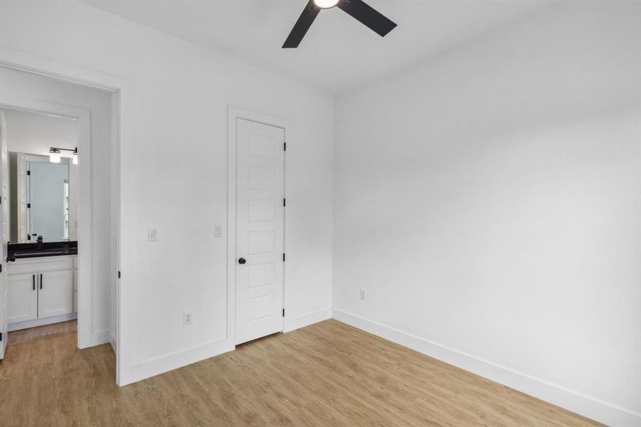 Unfurnished bedroom with light wood-type flooring and ceiling fan