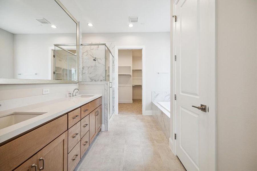 Primary bathroom retreat on the 3rd level offers a tranquil setting with a separate tub/shower.