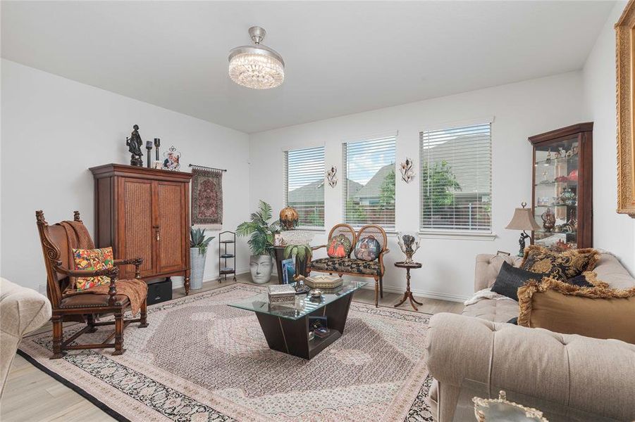 Living room with light hardwood / wood-style flooring and a chandelier