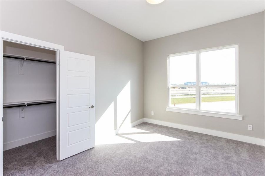 Unfurnished bedroom featuring a closet and carpet