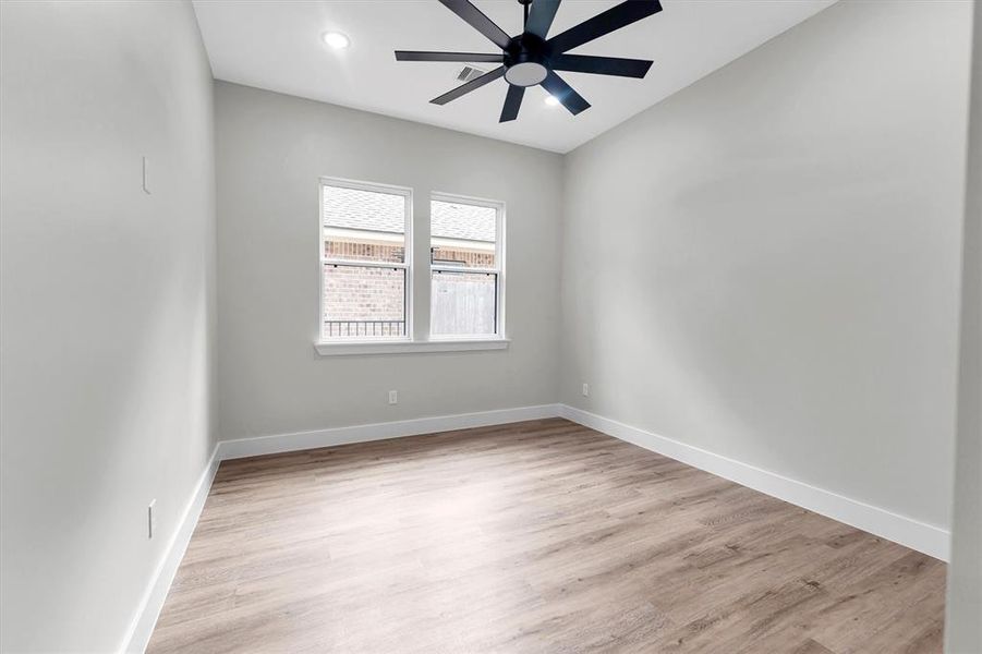 Third bedroom with ceiling fan and walk-in closet