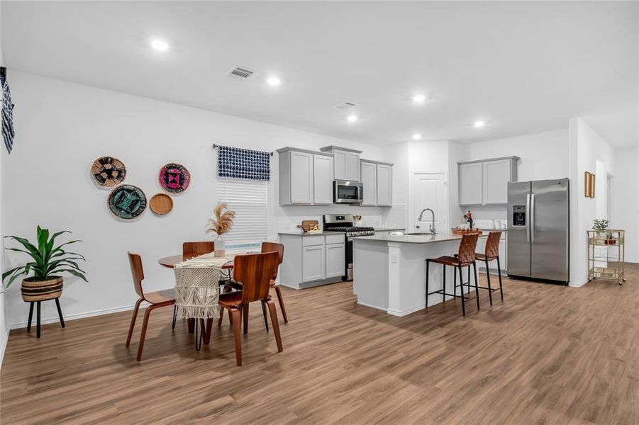 Kitchen is equipped with stainless steel appliances. Kitchen flows nicely into dining room.