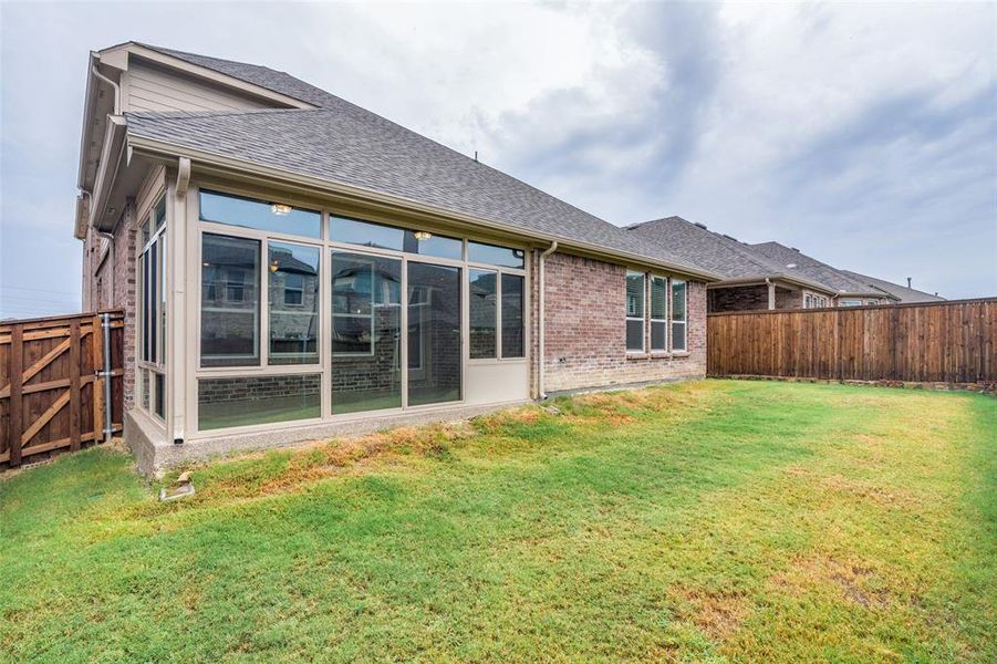 Back of house featuring a yard