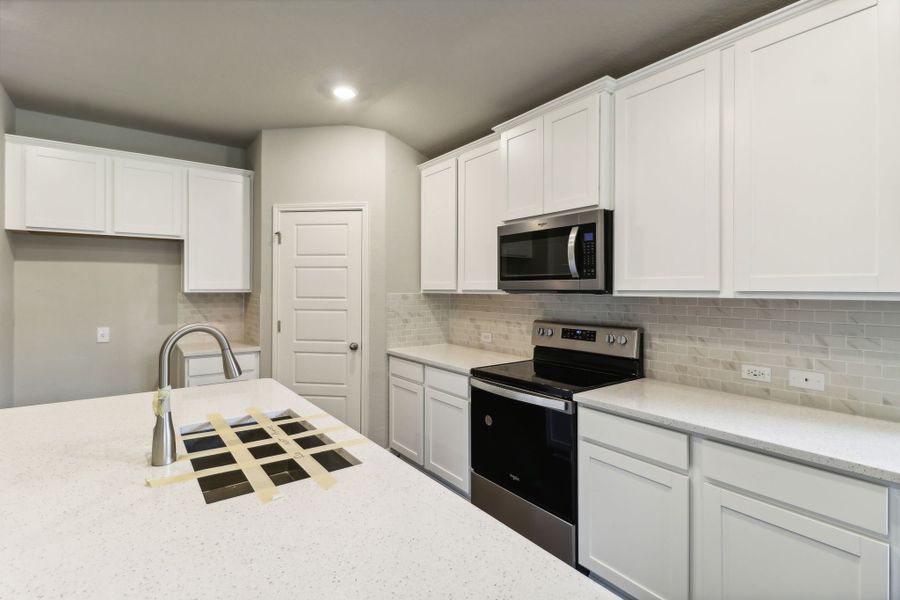 Kitchen in the Hughes floorplan at a Meritage Homes community.