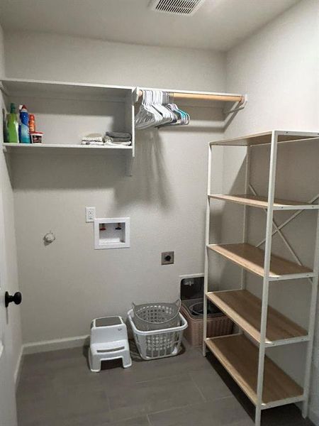 Laundry room with electric dryer hookup, gas dryer hookup, and hookup for a washing machine